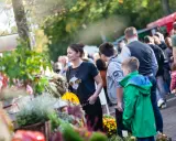 Menschen genießen bunte Veranstaltungen in OWL. Ein Markt mit Blumen und Ständen lockt Besucher an.