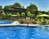 Entspannter Tag am Pool in Bad Sassendorf. Blaue Wasserflächen, Liegen unter Sonnenschirmen und ein Brunnen laden zum Verweilen ein.
