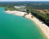Sonniger Tag am **Silbersee Haltern am See**. Tausende Besucher genießen das türkisfarbene Wasser und den breiten Sandstrand, umgeben von grünen Wäldern.